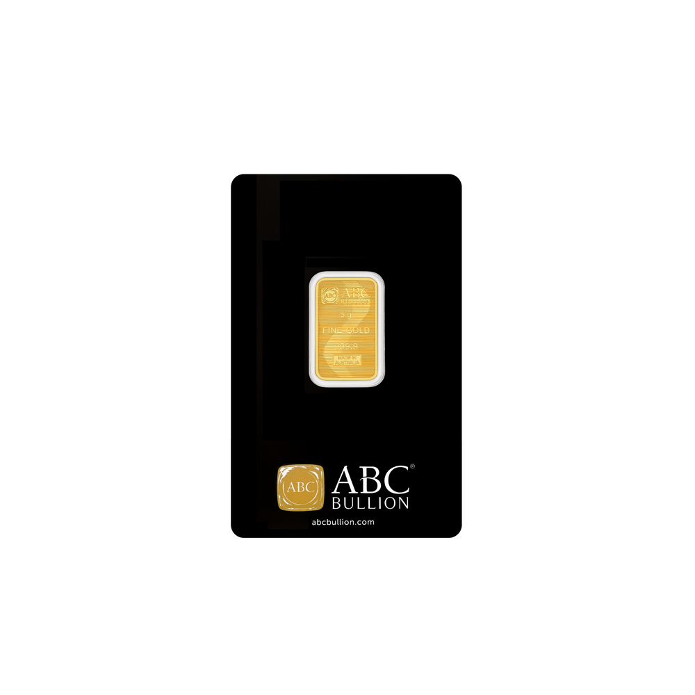 Gold bar in a black protective case with ABC Bullion branding on a white background